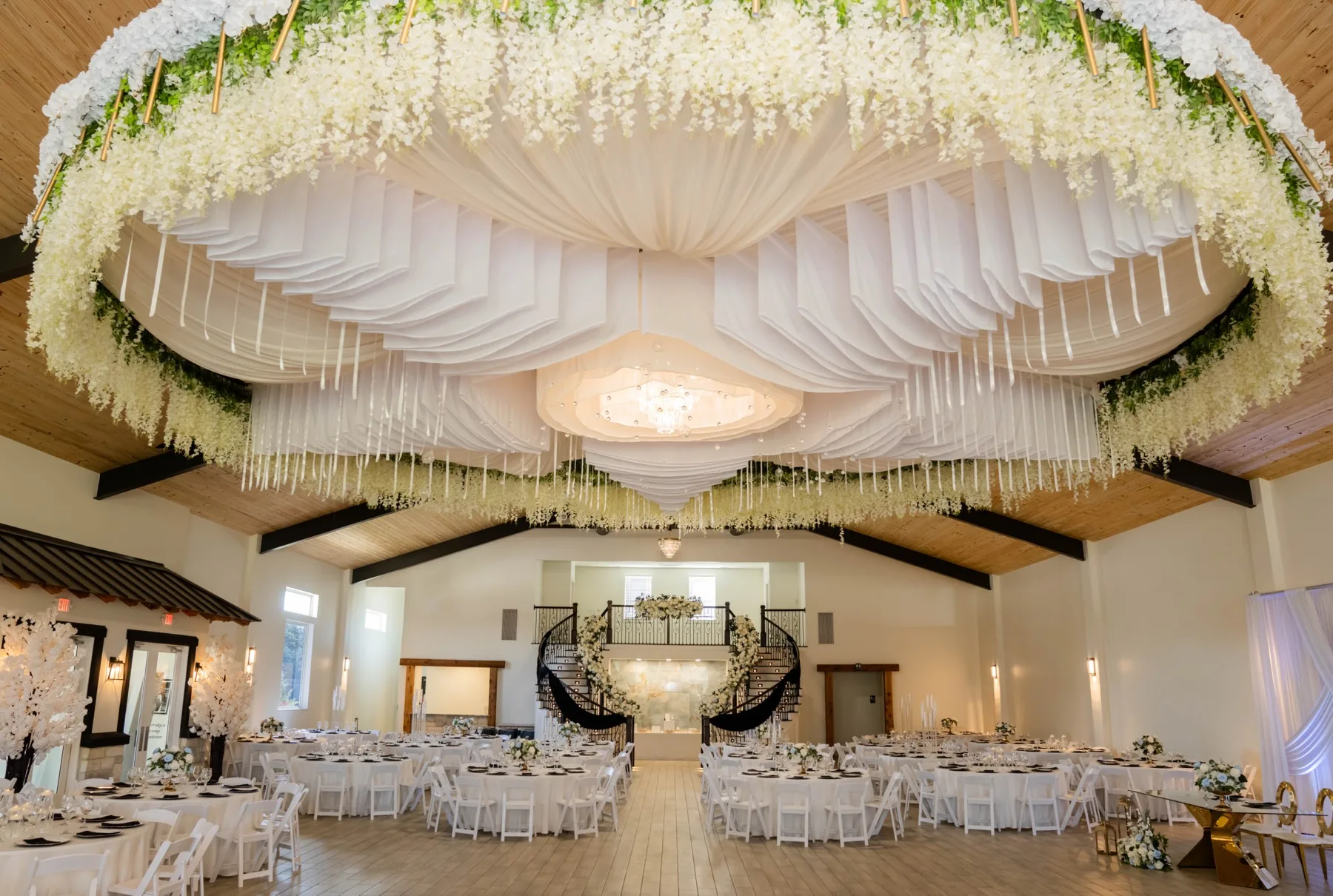 Ceiling floral installation over a luxury reception setup